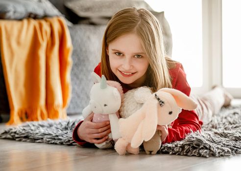 Girl with toys in bedroom