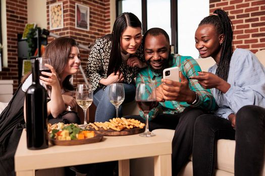 Diverse nationality group people staring at smartphone screen