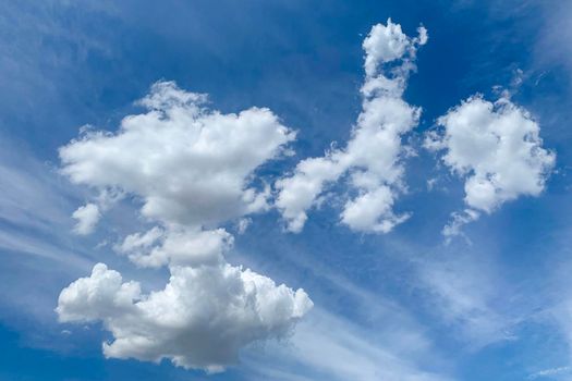 White clouds in blue sky. Beautiful fluffy clouds on blue heaven background.