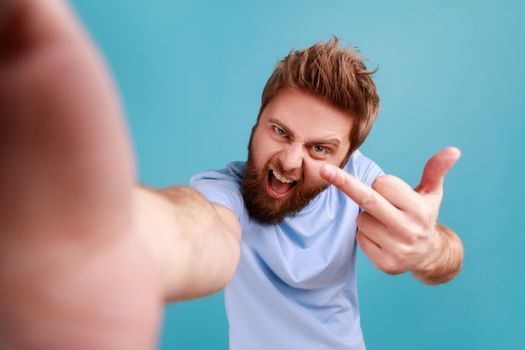 Man making point of view of photo, showing middle to camera, expressing anger and aggressive emotions