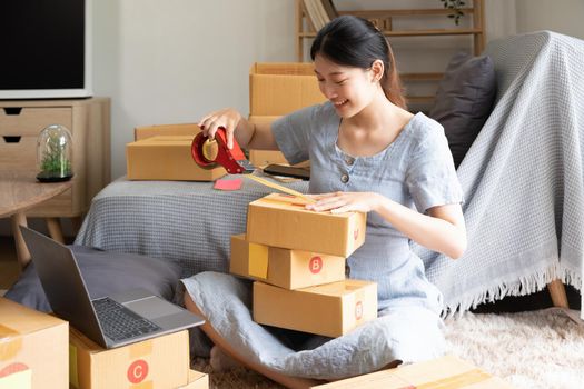 Young startup small business entrepreneur woman packing package post shipping box preparing delivery parcel , Online business, ecommerce and delivery concept.