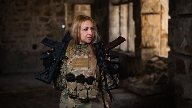 Blonde woman in army uniform holding a firearm in an abandoned building.