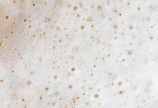 Beer foam top view. Soft fresh Foam on light beer. Bubble froth of beer. Beer foam texture background