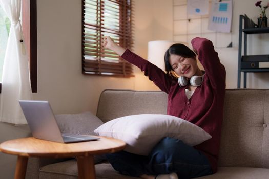 Young asian woman happy life sitting on couch cozy living room at home. The house was homely concept