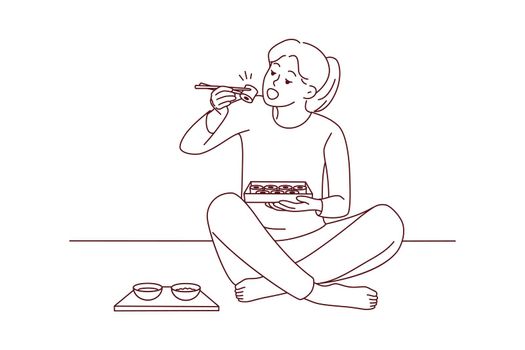 Woman sit on floor eating sushi
