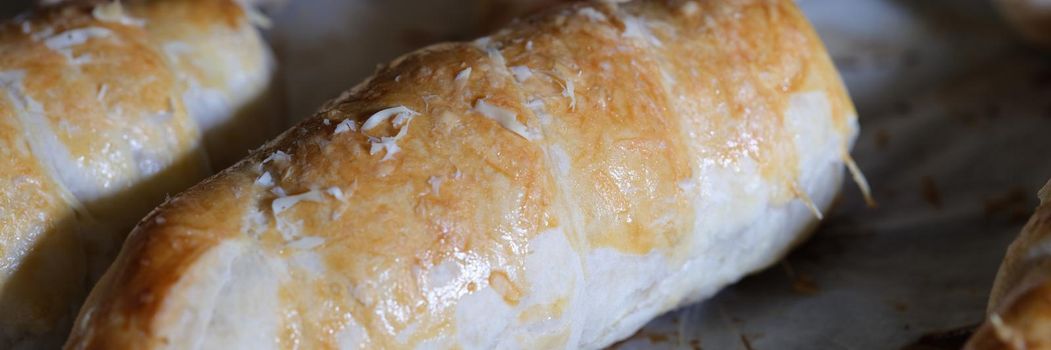 Closeup of delicious appetizing homemade buns on baking sheet