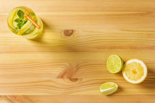 Homemade lemon soda for summer on wooden table