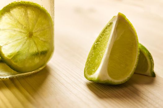 slices of lime and lemonade on a wooden table