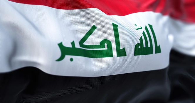Close-up view of the Iraq national flag waving in the wind