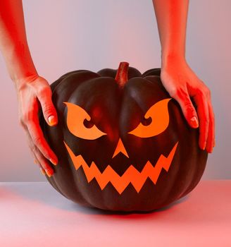 Halloween Pumpkin with Paper Cut Scary Face in trend red color. Jack Halloween. Smile Jack Pumpkin