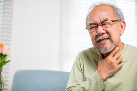 Asian old man painful in the sore throat