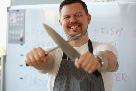 Portrait of blogger chef in apron holding knife