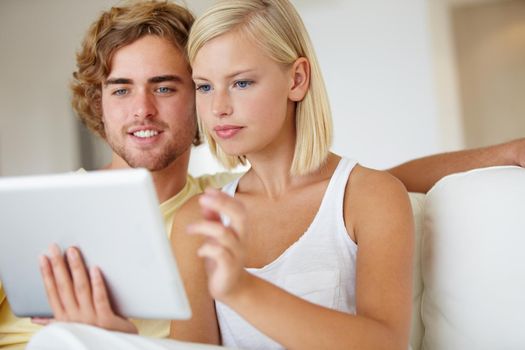Once you have it youll wonder why you didnt sooner. A happy young couple using a tablet together in their lounge