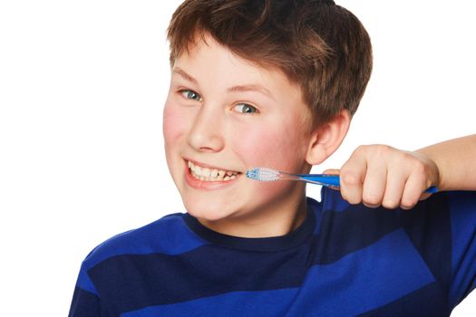 You gotta remember to brush. Portrait of a young boy brushing his teeth.