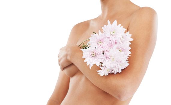 Natural beauty. A bare pregnant woman holding a bouquet of flowers while isolated on a white background.