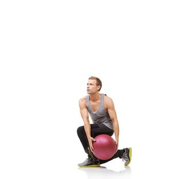 Squats are good for the thighs. A young man working out with a medicine ball on a white background.