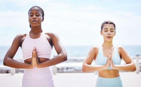 Yoga, zen and meditation with girl friends outdoor for training, workout and exercise on the beach. Fitness, sport and health with a female and friend exercising during summer for spiritual wellness