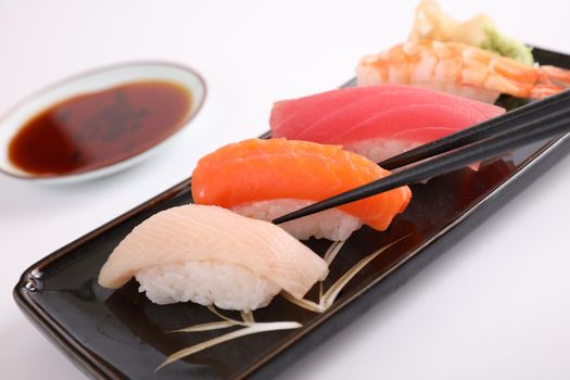 Sushi set , Japanese food sushi salmon tuna shrimp  and sea bass with chopsticks isolated in white background