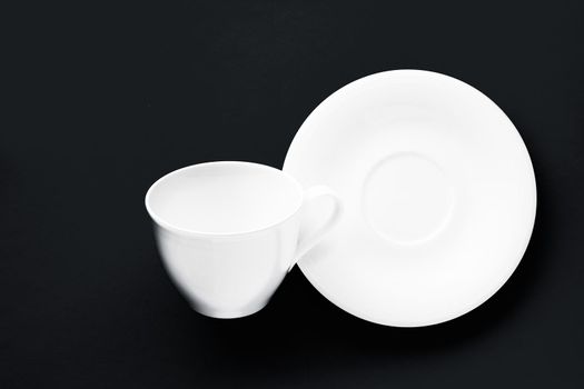 White tableware crockery set, empty cup on black flatlay background