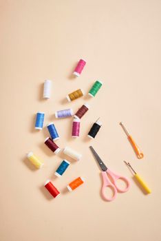 tools for needlework thread scissors and tape measure isolated on biege background 