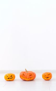 Banner Jack-o-lantern carved pumpkin on light wall background with copy space, autumn and halloween home decor instagram stories