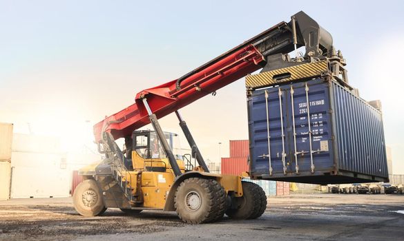 Transport, logistics and supply chain with container storage and a crane vehicle on a commercial dock. Shipping, cargo and freight in an empty yard for export, import and delivery of goods or service