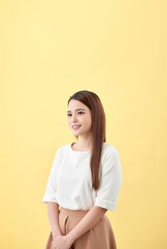 Asian woman smiling with dimple long hair black eyes on yellow background