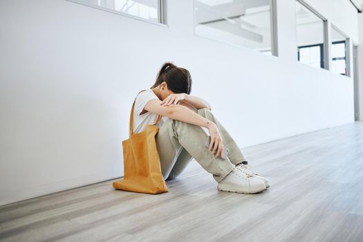 Depression, stress and woman on the floor on an office, frustrated and suffering with mental health problem. Burnout, anxiety and pressure by jobless female feeling hopeless looking for a job