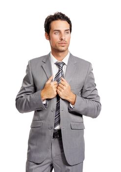 Thoughtful executive. A good-looking young businessman holding the lapels of his jacket and looking away thoughtfully.