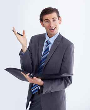 Oh, you dont say. A delighted young businessman holding his notebook and gesturing happily.