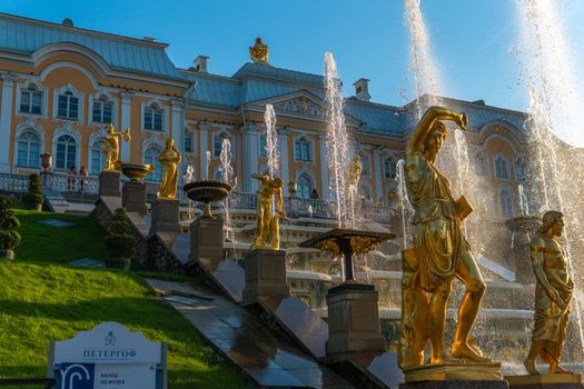 RUSSIA, PETERSBURG - AUG 19, 2022: fountain palace russia peterhof petersburg grand st cascade travel, from baroque blue in garden for saint sky, dome cross. Tourism baluster luxury,