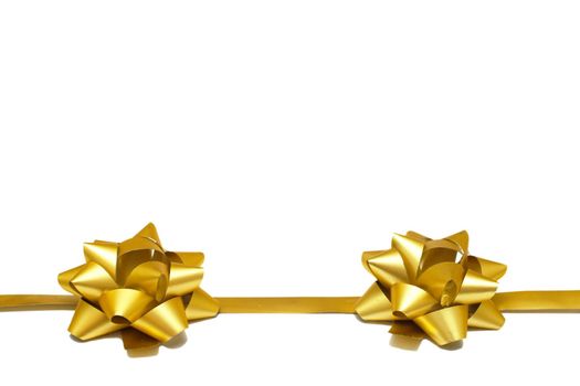 Two golden gift bows with a ribbon on a white background with copy space. isolated object. Universal template for postcards, posters, banners
