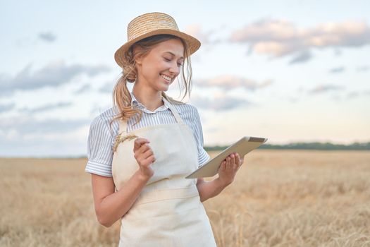 Woman farmer straw hat smart farming standing farmland smiling using digital tablet Female agronomist specialist research monitoring analysis data agribusiness