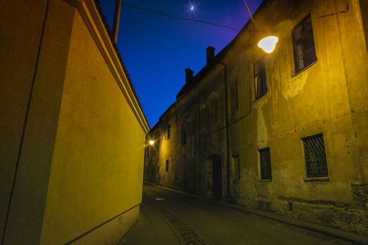 Vilnius old town, mystery street illuminated at night, Lithuania
