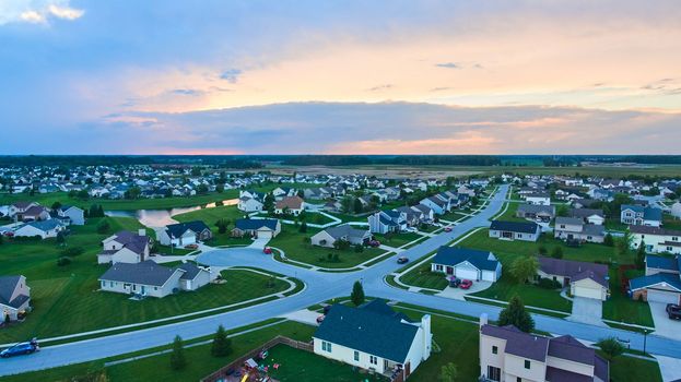 Midwest American suburban neighborhood housing aerial at dusk