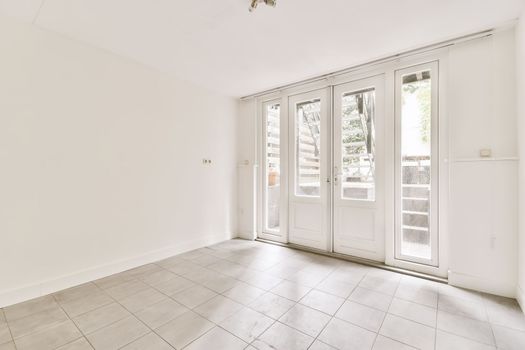 a living room with french doors and a tile floor