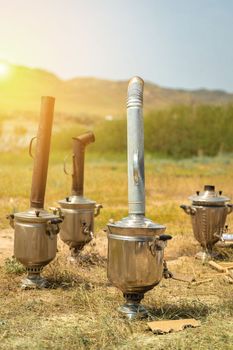 Boiling samovar in the steppe, Catering travel outdoor, copy space, vertical
