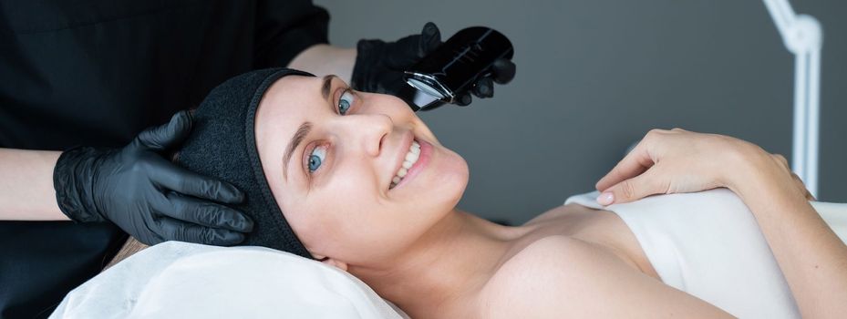 Woman on ultrasonic cleaning procedure. Hardware cosmetology.