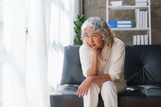 Pensive older woman lonely old senior in is home