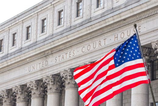 USA national flag waving in the wind in front of United States Court House in New York