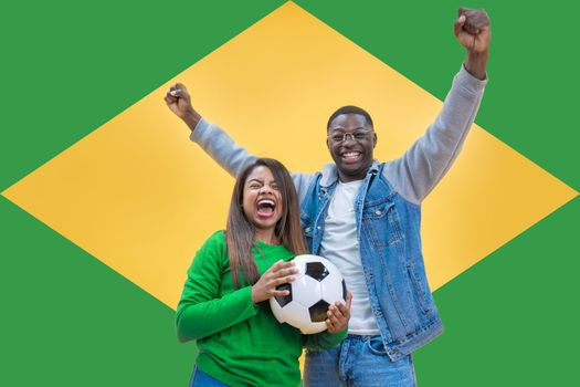 Brazilian fans couple happy celebrating football or soccer game on yellow and green background