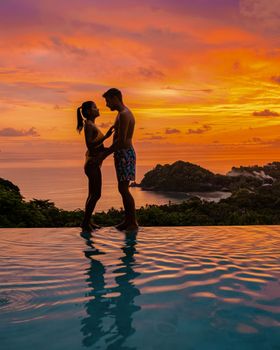couple in infinity pool in Thailand looking out over the ocean, luxury vacation in Thailand