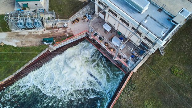 Drone looking down at dam releasing water for river