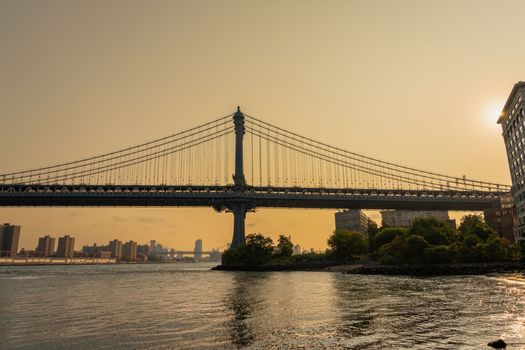 Manhattan bridge photo in profile in the tones of the rising sun