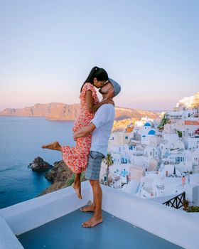 Santorini Greece, young couple on luxury vacation at the Island of Santorini 