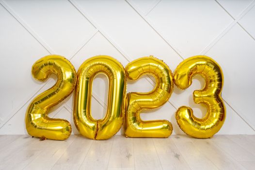 Banner with 2023 golden foil inflatable balloons. Christmas and 2023 New Year Holidays concept.