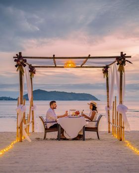 couple having a romantic dinner on the beach of Phuket Thailand