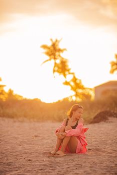 Cute teen beautiful girl on tropical seashore at sunset