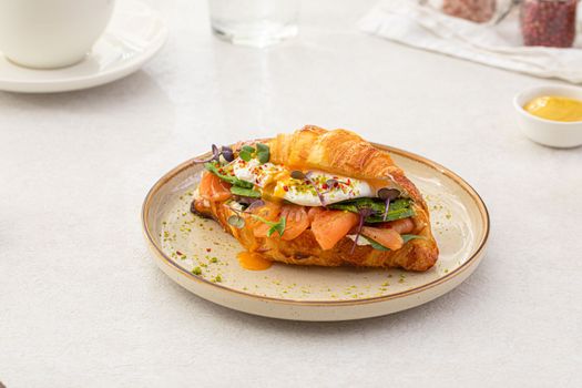 Portion of salmon croissant sandwich
