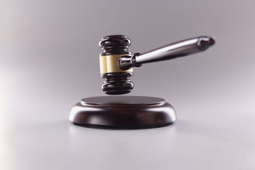 Brown wooden judge gavel in air closeup